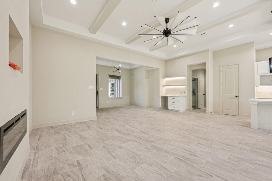 s living area features modern tile flooring, recessed lighting, and a contemporary Another view of the living area showing the coffee space, ceiling fan. and great open layout.