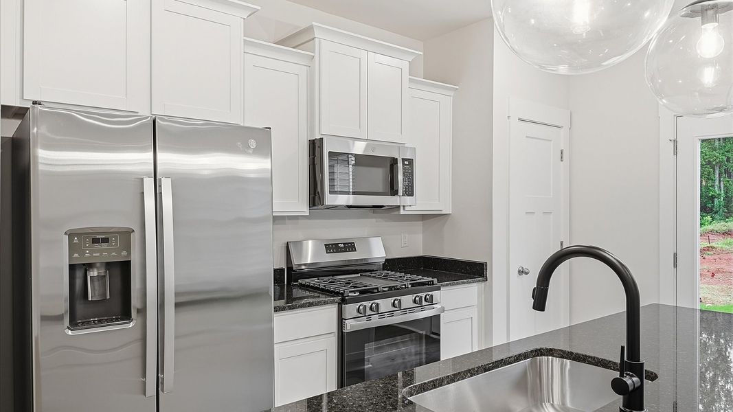 Notable kitchen space with elegant pendant lighting and a center island perfect for entertaining in Lyman, SC