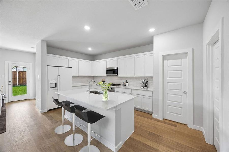 Kitchen in the Oscar home plan by Trophy Signature Homes – REPRESENTATIVE PHOTO Kitchen in the Oscar home plan by Trophy Signature Homes – REPRESENTATIVE PHOTO