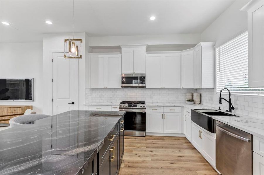 Another view of the kitchen. The massive island is 100% natural quartz and provides plenty of seating for friends & family.