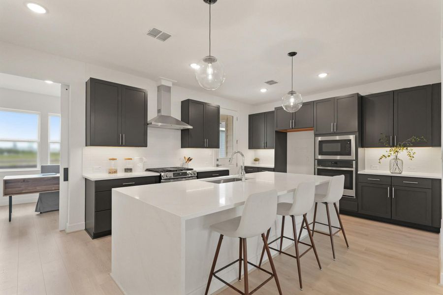 Gorgeous kitchen with grey cabinets and quartz counters (*Photo not of actual home and used for illustration purposes only.)
