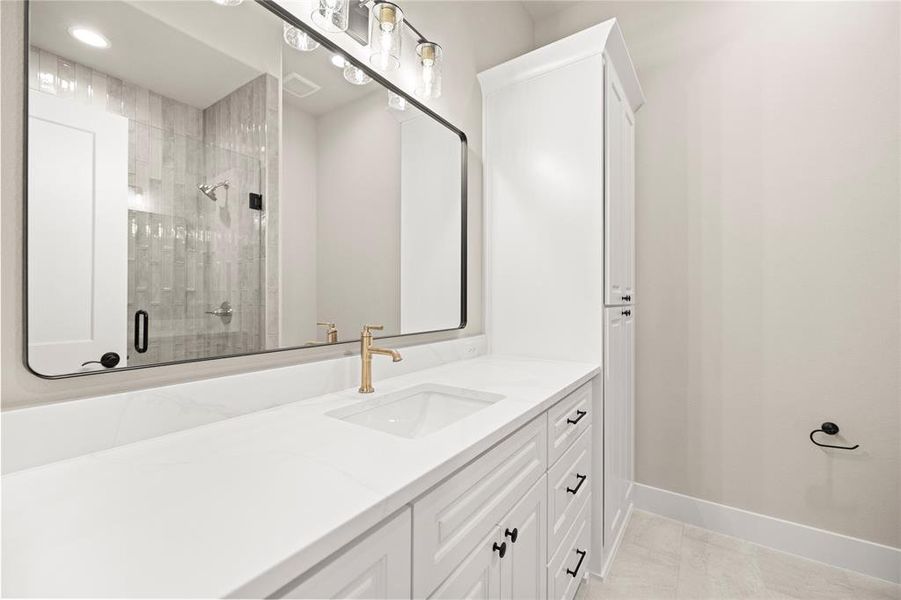 Bathroom with vanity, a stall shower, and light tile patterned floors Bathroom with vanity, a stall shower, and light tile patterned floors