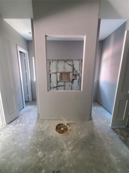 PRIMARY BATH WITH A SOAKING TUB TO BE INSTALLED AND A WALK-THROUGH SHOWER TO BE COMPLETED BEHIND IT.