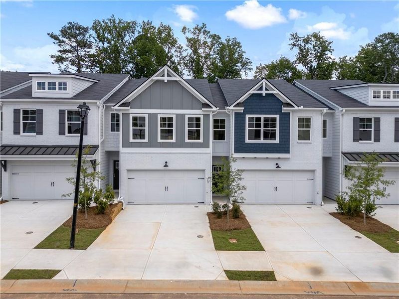 Front exterior of a new home in Shoals Crossing, Conyers, GA, highlighting curb appeal (Image 1). Front exterior of a new home in Shoals Crossing, Conyers, GA, highlighting curb appeal (Image 1).