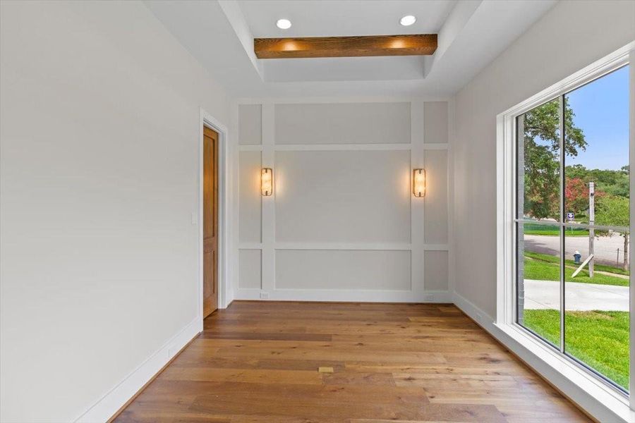 Office located in front of home features oak beams, sconces, storage closet and large windows.  Floor outlet allows for ideal desk placement.