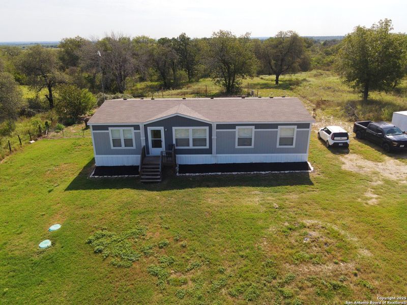 Front exterior of a new home in , Somerset, TX, highlighting curb appeal (Image 21). Front exterior of a new home in , Somerset, TX, highlighting curb appeal (Image 21).