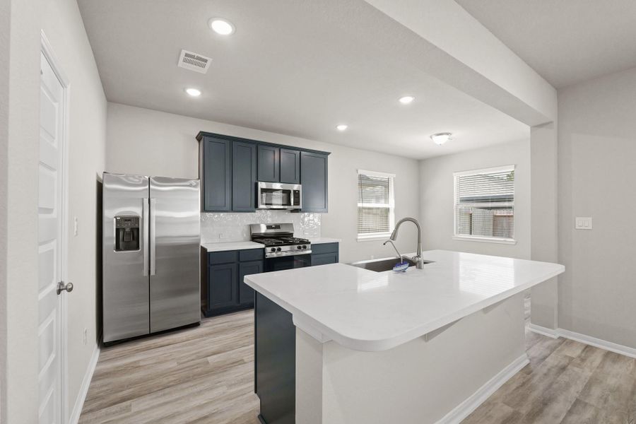 Stunning kitchen with blue cabinets and quartz countertops