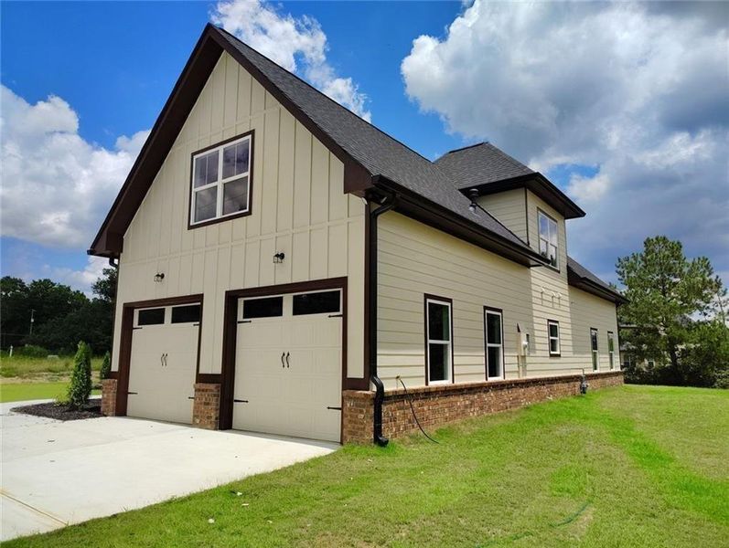 Front exterior of a new home in , Loganville, GA, highlighting curb appeal (Image 1). Front exterior of a new home in , Loganville, GA, highlighting curb appeal (Image 1).
