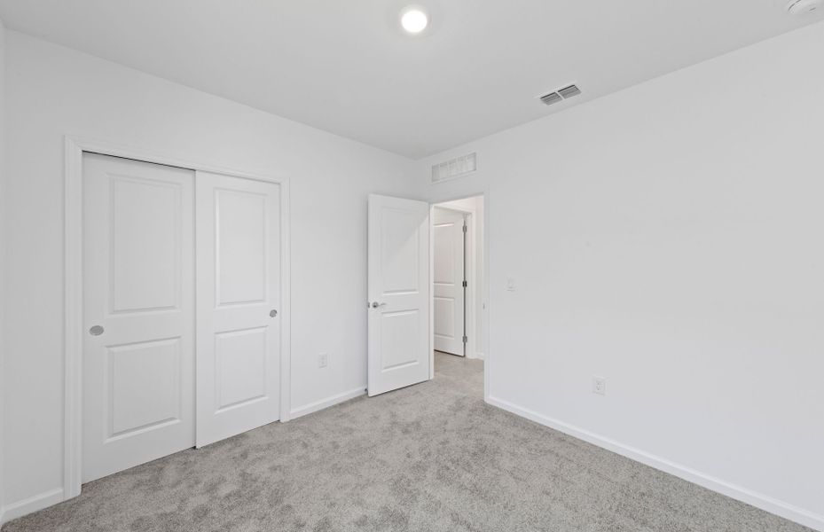 Third bedroom with sliding closet doors