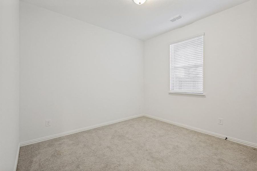 Carpeted room with a single window featuring horizontal blinds