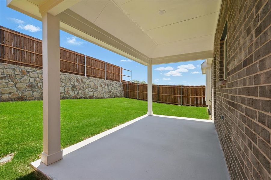 Fenced backyard featuring a patio area Fenced backyard featuring a patio area