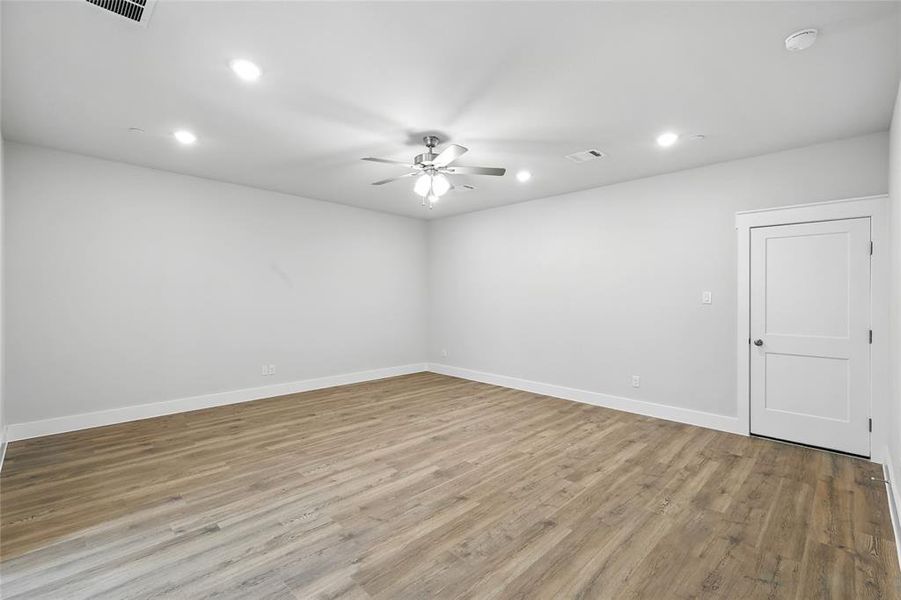 Empty room with light wood finished floors, recessed lighting, and ceiling fan