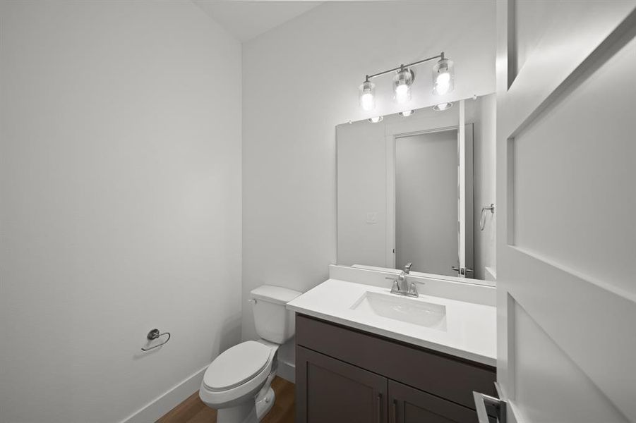 Half bathroom with toilet and vanity