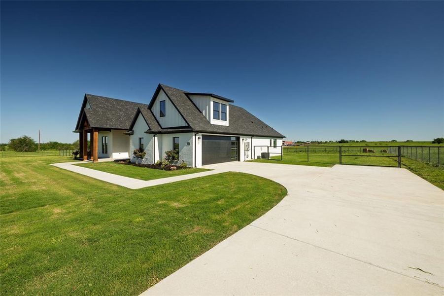 View of front of property featuring fence, a garage, a shingled roof, concrete driveway, and a front lawn View of front of property featuring fence, a garage, a shingled roof, concrete driveway, and a front lawn