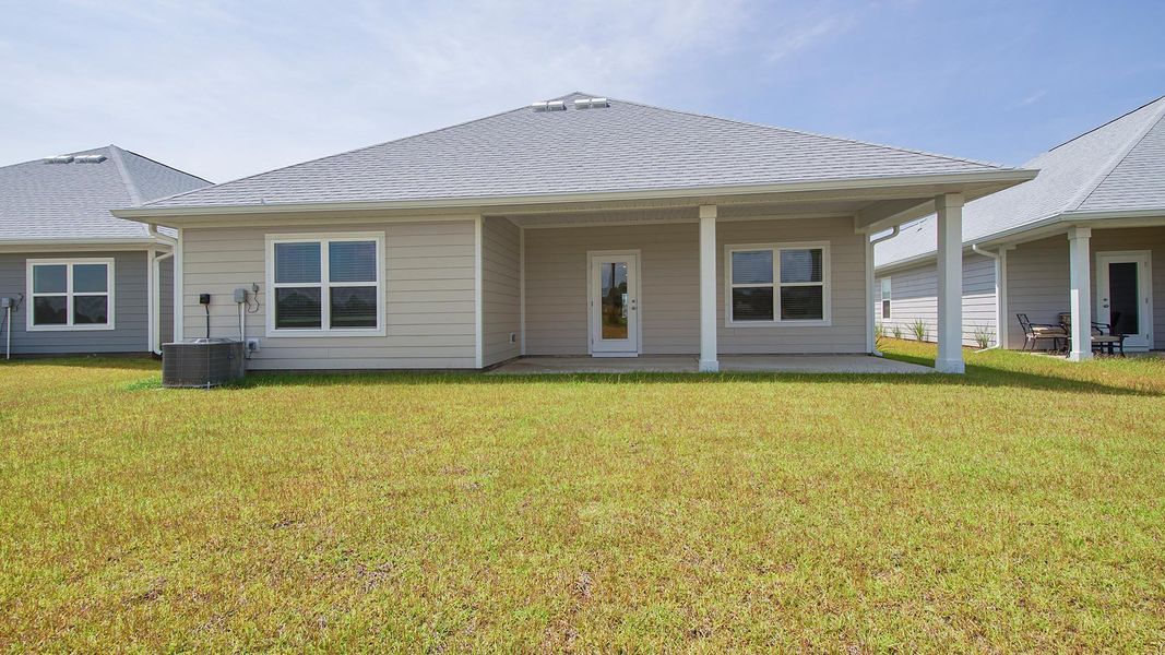 Front exterior of a new home in Caballeros Estates At Hombre, Panama City Beach, FL, highlighting curb appeal (Image 18).