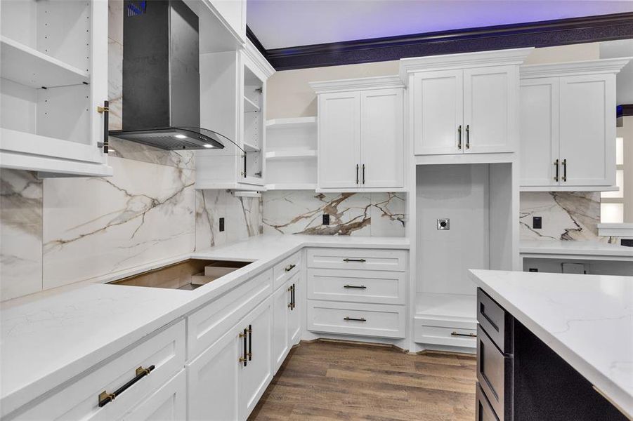 Other views of the kitchen. Notice the number of drawers, cabinets, shelves and the extra added trim work on these custom cabinets.