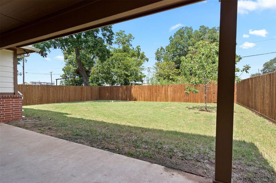 Fenced backyard featuring a patio area