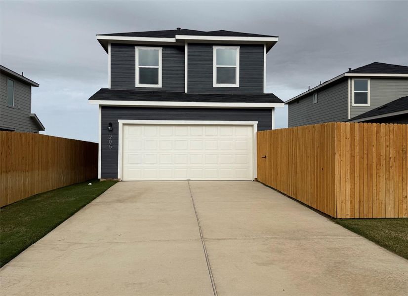 Front exterior of a new home in Valverde, Bastrop, TX, highlighting curb appeal (Image 1).