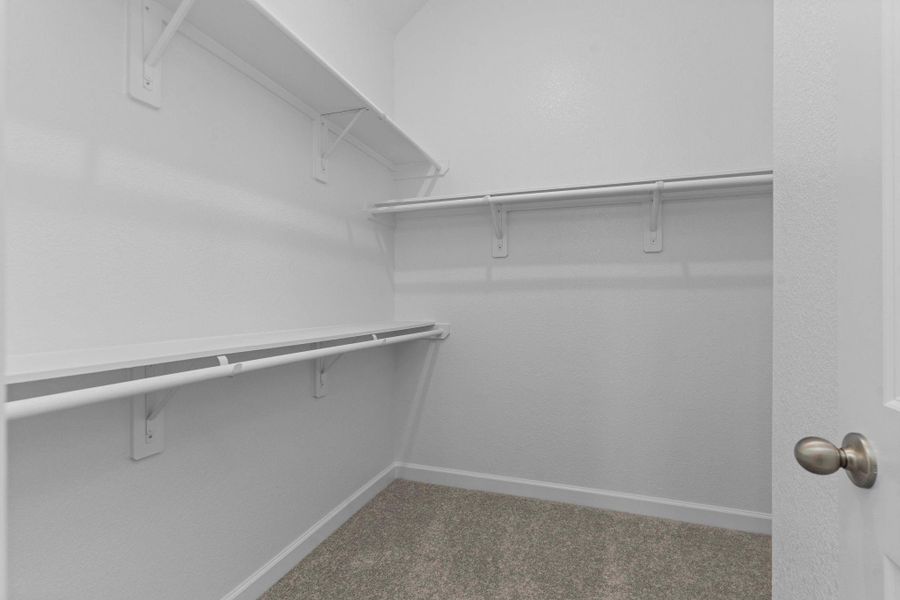 Another view of the generous walk-in closet, showcasing its depth and versatility to keep everything neatly in place. Another view of the generous walk-in closet, showcasing its depth and versatility to keep everything neatly in place.