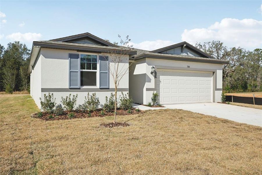 Front exterior of a new home in Leyland Preserve - Classic Series, Brooksville, FL, highlighting curb appeal (Image 20).