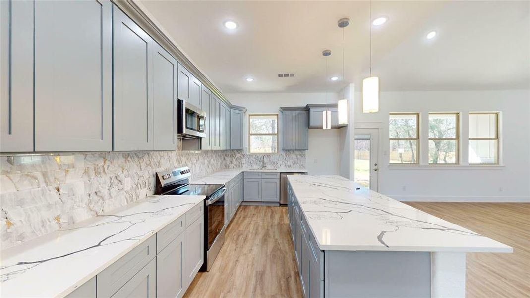 Kitchen featuring visible vents, appliances with stainless steel finishes, and gray cabinetry