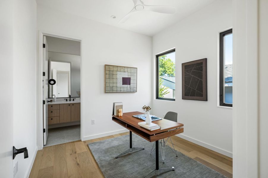 Clean lines and warm wood floors define this light-filled modern home office.