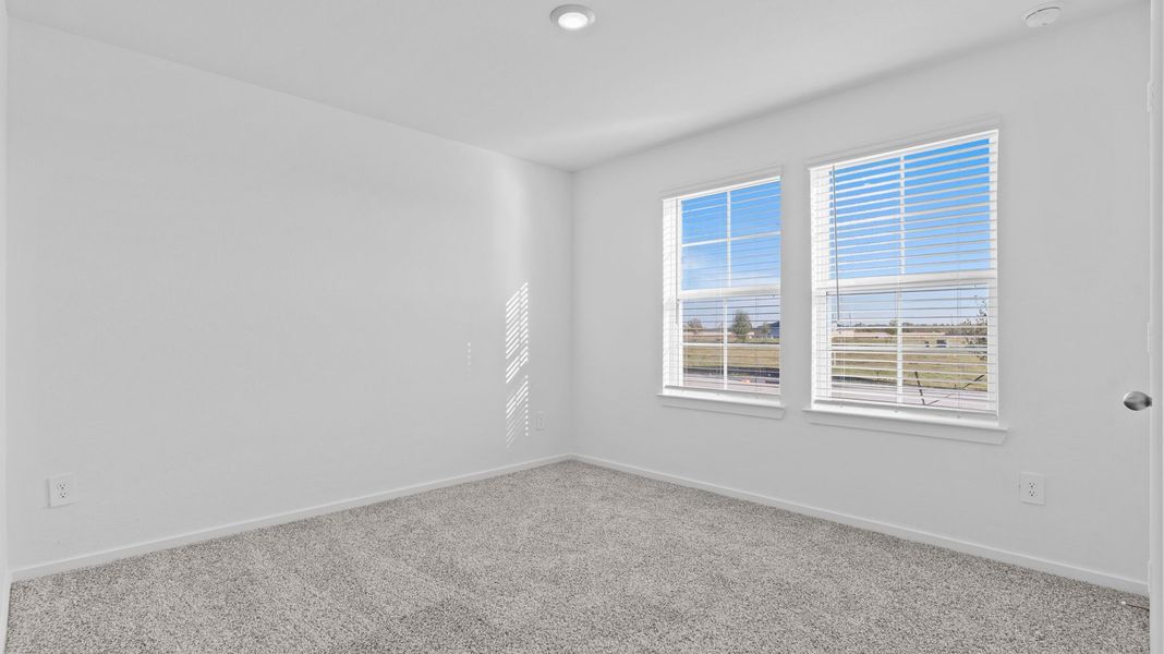 Spacious, unfurnished interior of a new home in Caldwell Crossing, Iowa Colony (Image 13).