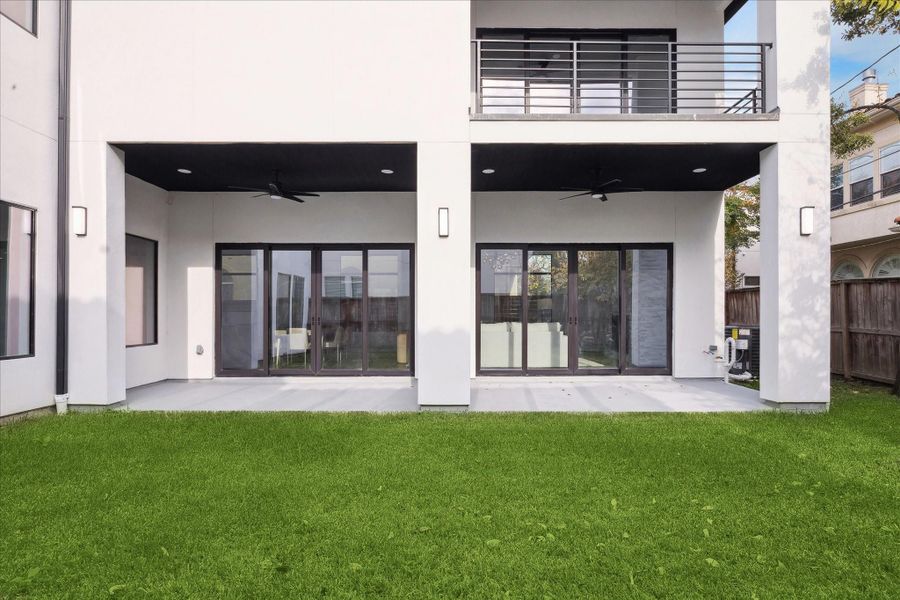 This perspective emphasizes the outdoor patio, demonstrating the home’s seamless indoor-outdoor flow and versatile entertainment space.