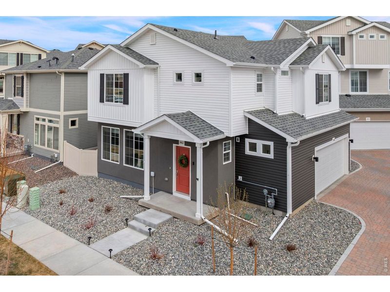 Front exterior of a new home in Thompson River Ranch, Johnstown, CO, highlighting curb appeal (Image 2).