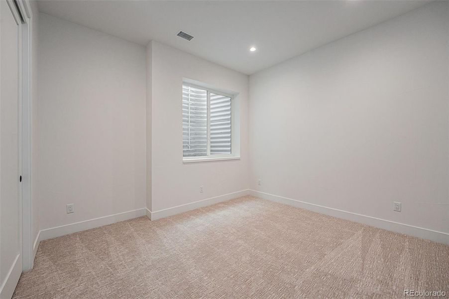 5th conforming bedroom in the basement with walk-in closet