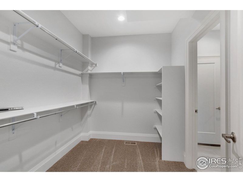 The primary closet isn't lacking for space, and has direct access to the laundry room