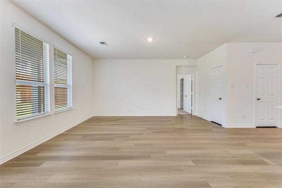 Empty room featuring light wood-style flooring and recessed lighting Empty room featuring light wood-style flooring and recessed lighting
