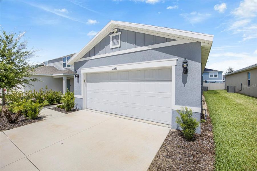 Front exterior of a new home in Belle Haven, Davenport, FL, highlighting curb appeal (Image 20). Front exterior of a new home in Belle Haven, Davenport, FL, highlighting curb appeal (Image 20).