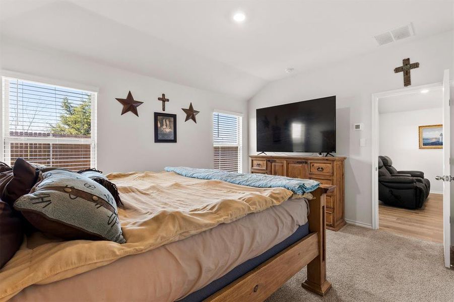 Bedroom featuring lofted ceiling, light colored carpet, and recessed lighting Bedroom featuring lofted ceiling, light colored carpet, and recessed lighting