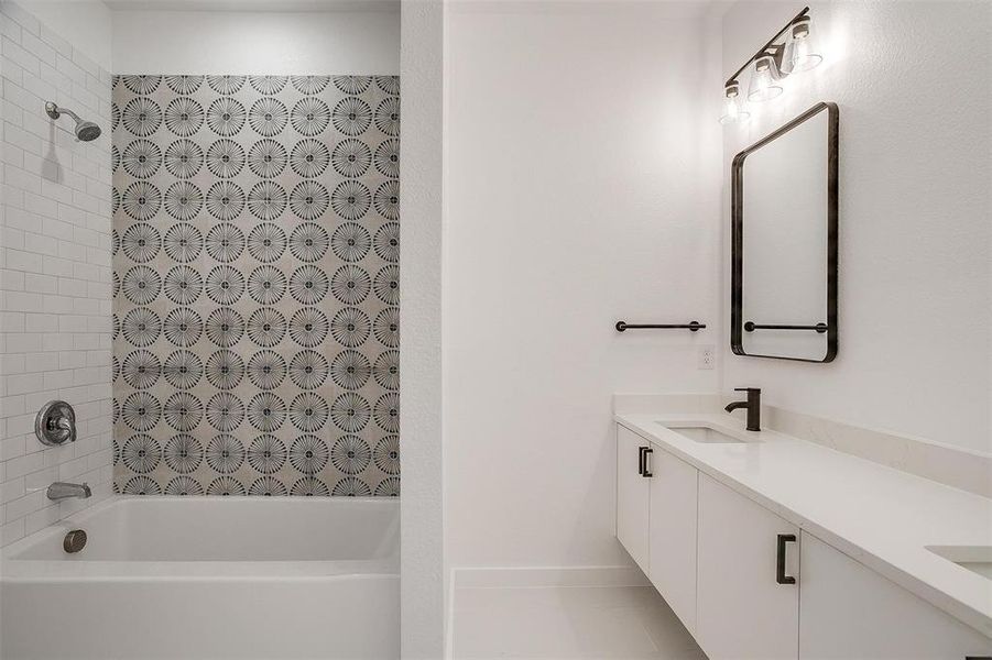 Bathroom featuring tiled shower / bath and vanity Bathroom featuring tiled shower / bath and vanity