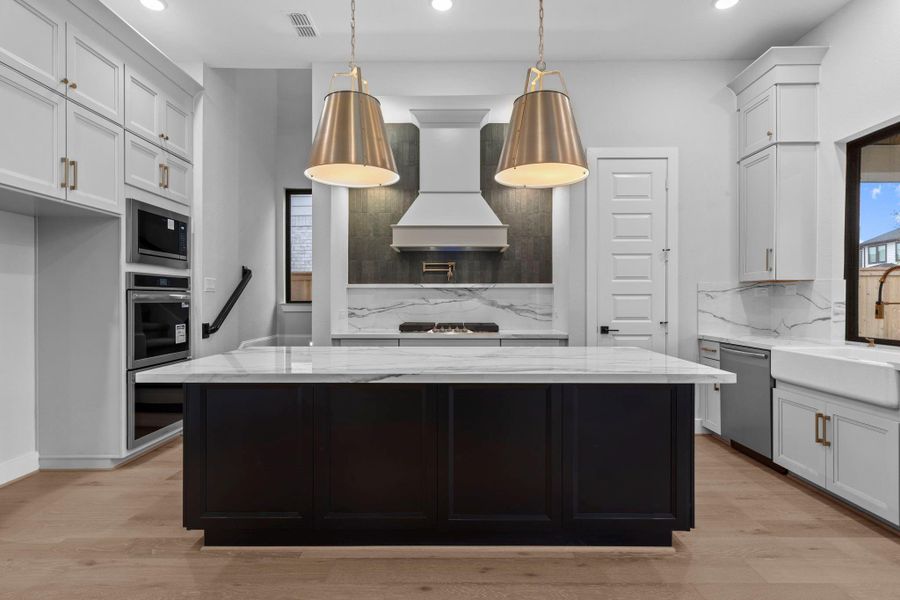The lighting in this home is beautiful. Notice the back staircase that conveniently takes you right up to the game room.