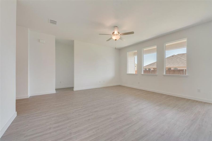 Spare room with light wood-type flooring and ceiling fan