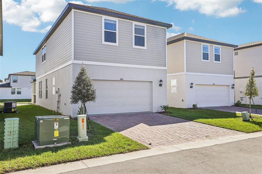 Front exterior of a new home in The Meadow at Crossprairie Bungalows, St. Cloud, FL, highlighting curb appeal (Image 18).