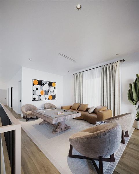 Living area featuring wood finished floors and recessed lighting Living area featuring wood finished floors and recessed lighting