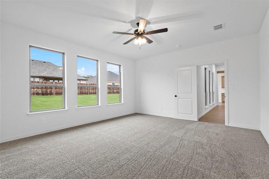 Unfurnished room featuring ceiling fan and carpet floors