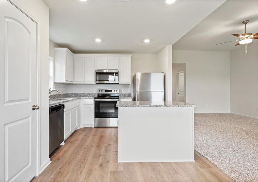 The kitchen of the Blanco has beautiful white wood cabinets.