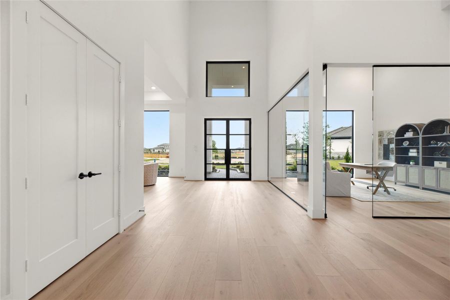 Expansive entry with high ceilings and glass-framed views offering plenty of natural light leading into the main living areas. Expansive entry with high ceilings and glass-framed views offering plenty of natural light leading into the main living areas.