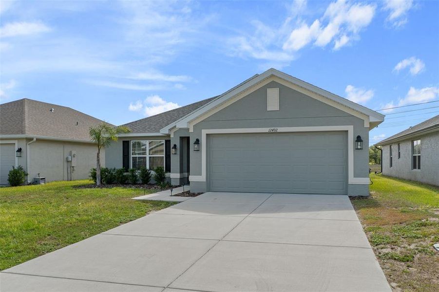 Front exterior of a new home in Pine Bluff, Spring Hill, FL, highlighting curb appeal (Image 22).