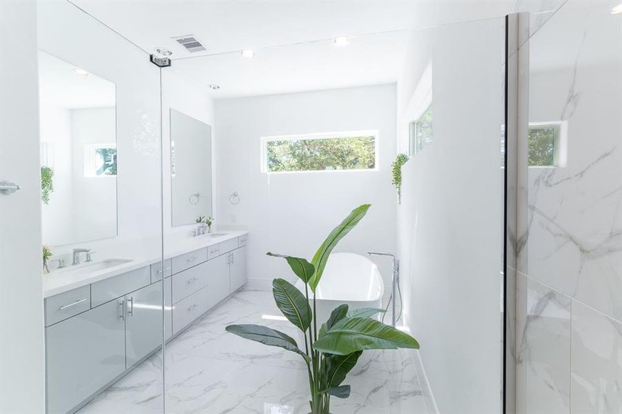 Elite/ clean lined Primary Bath with elevated windows bringing the natural light in.