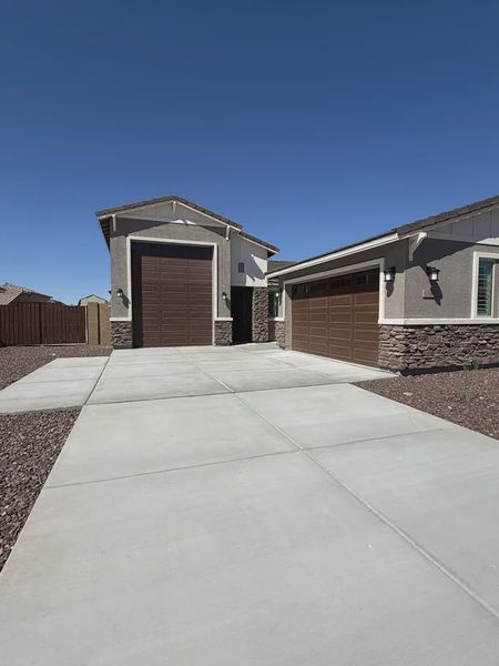 Front exterior of a new home in Las Barrancas, Yuma, AZ, highlighting curb appeal (Image 2). Front exterior of a new home in Las Barrancas, Yuma, AZ, highlighting curb appeal (Image 2).