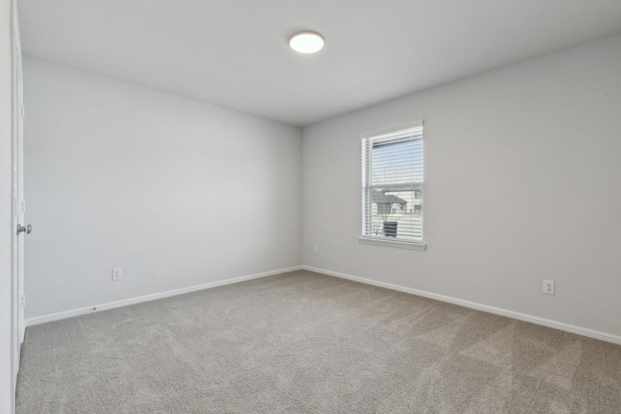 Bedroom in the Hayden home plan by Trophy Signature Homes – REPRESENTATIVE PHOTO