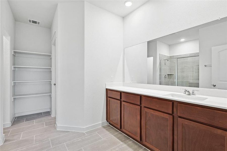 Bathroom with vanity and a shower with door