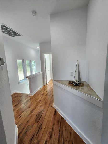 Corridor featuring wood-type flooring