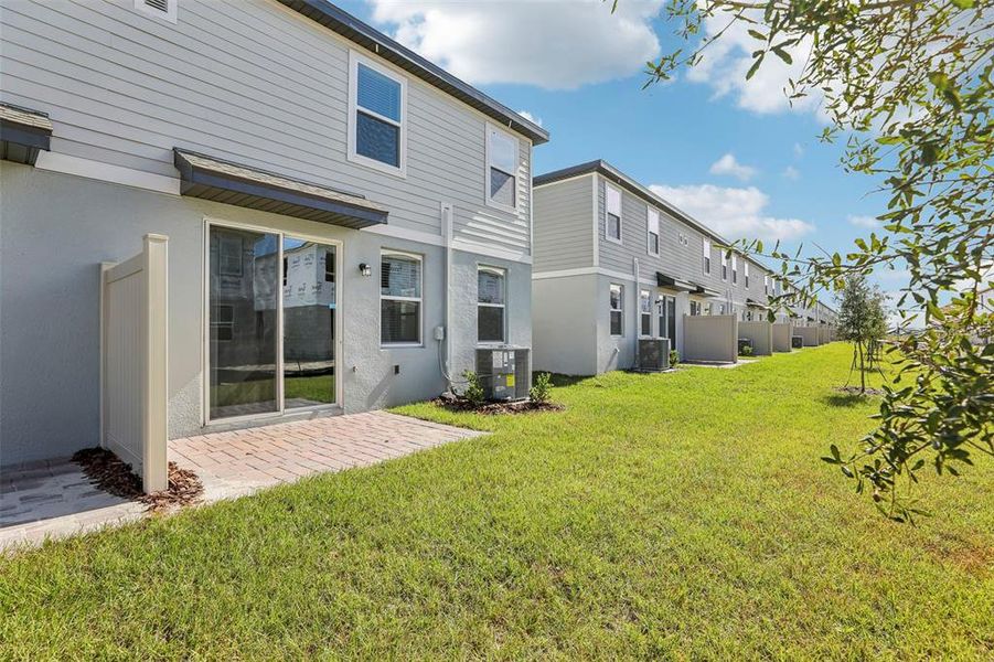 Exterior details and patio area of a home in The Meadow at Crossprairie Townes, St. Cloud (Image 24).
