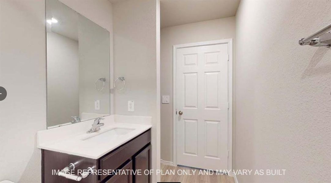 Bathroom featuring vanity and light wood finished floors